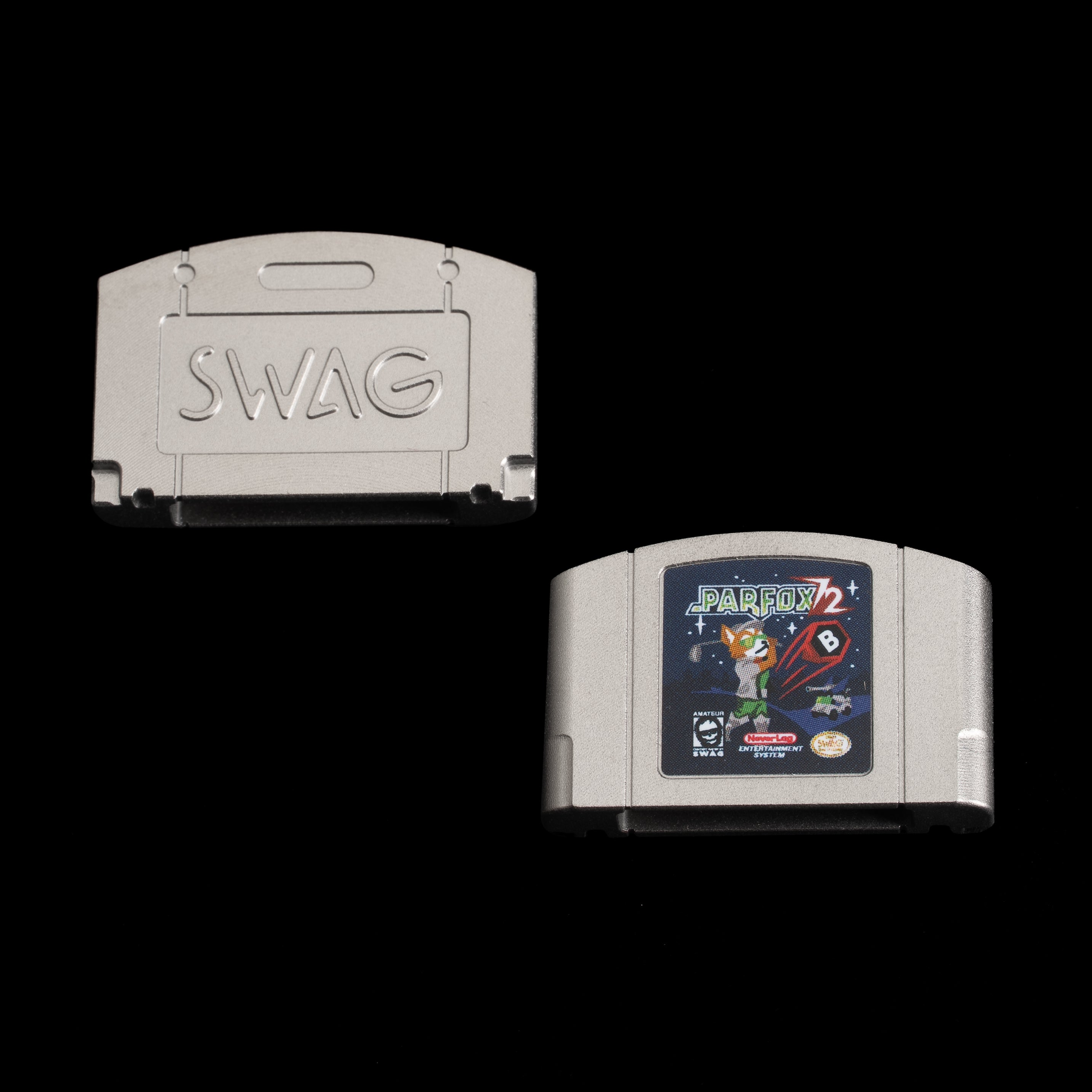 Stainless steel ball marker shaped like a retro cartridge with Parfox 72 adventure artwork and SWAG logo.