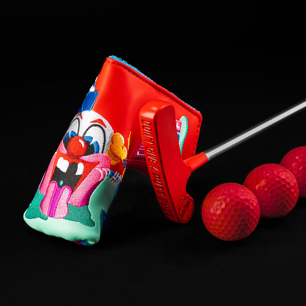 Red Putt-Putt putter with “Don’t Give a Putt-Putt” engraving, shown with the red clown cover and red golf balls.