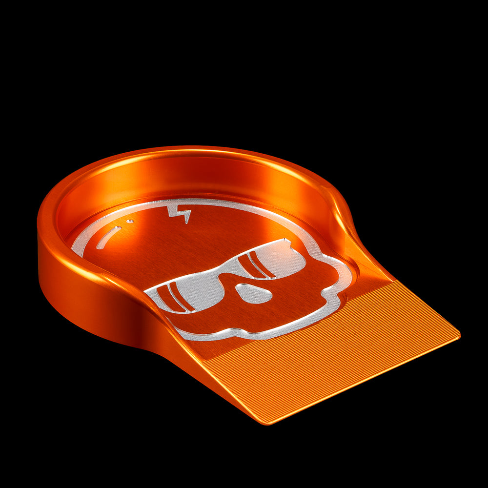SWAG Golf orange aluminum skull putting cup training accessory.