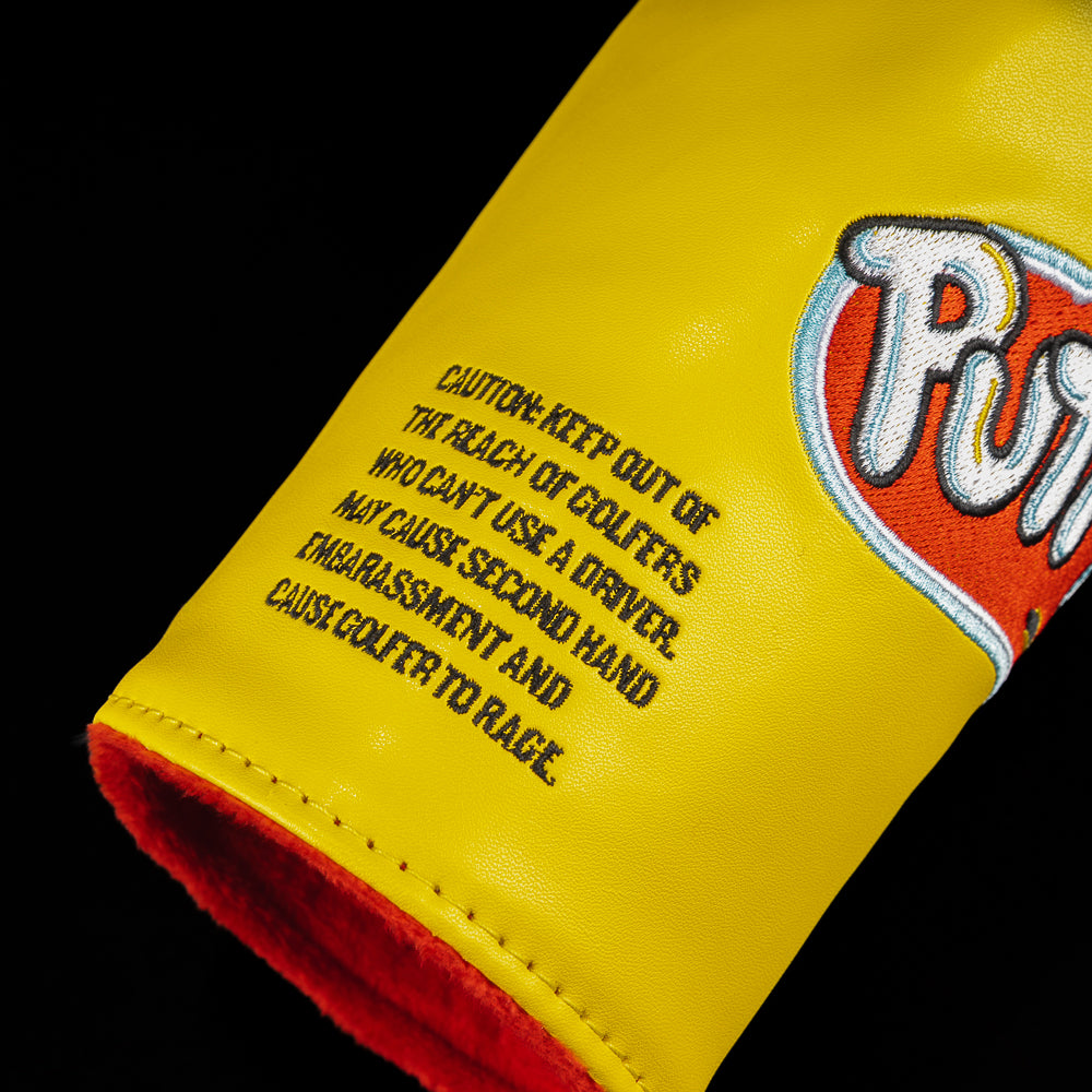 Side view of the Putt-4-Doh Barrel Fairway Cover showing the embroidered caution label that reads "Caution: Keep out of the reach of golfers who can't use a driver. May cause second hand embarrassment and cause golfer to rage."