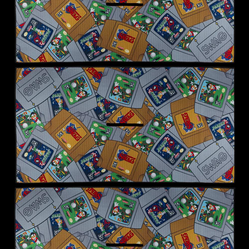 SWAG Golf towel featuring colorful stacked retro cartridge illustrations in an all-over print.