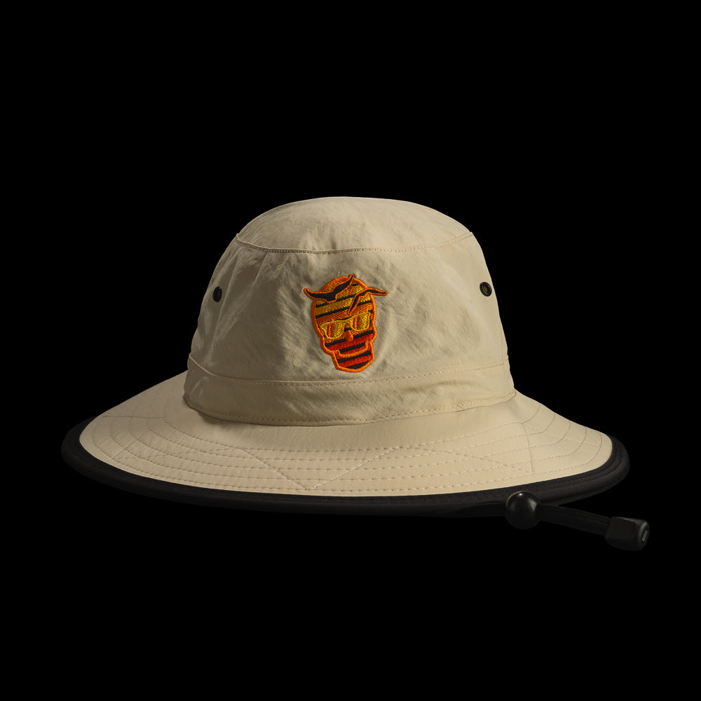 Beige bucket hat with a SWAG sunset skull logo on a black background