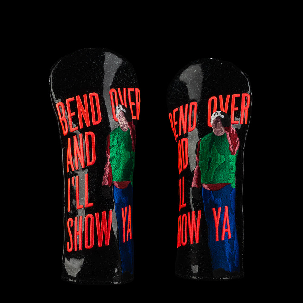 Black fairway cover with red holiday quote "bend over and i'll show ya" and pop-art man in green and blue outfit.