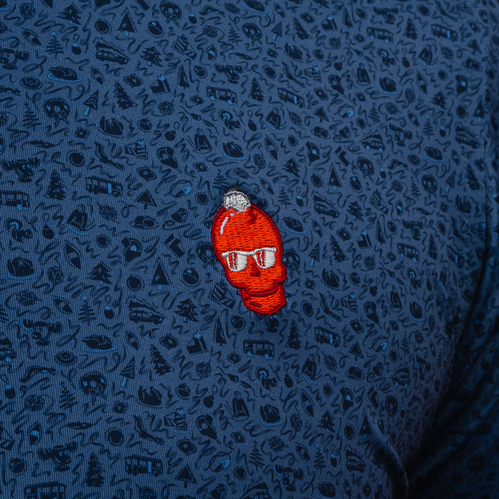 Blue Peter Millar holiday themed patterned men's performance golf polo shirt with a red ornament skull logo.