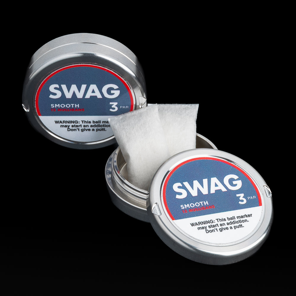 Two SWAG Golf smooth golf ball markers with one open on a black background