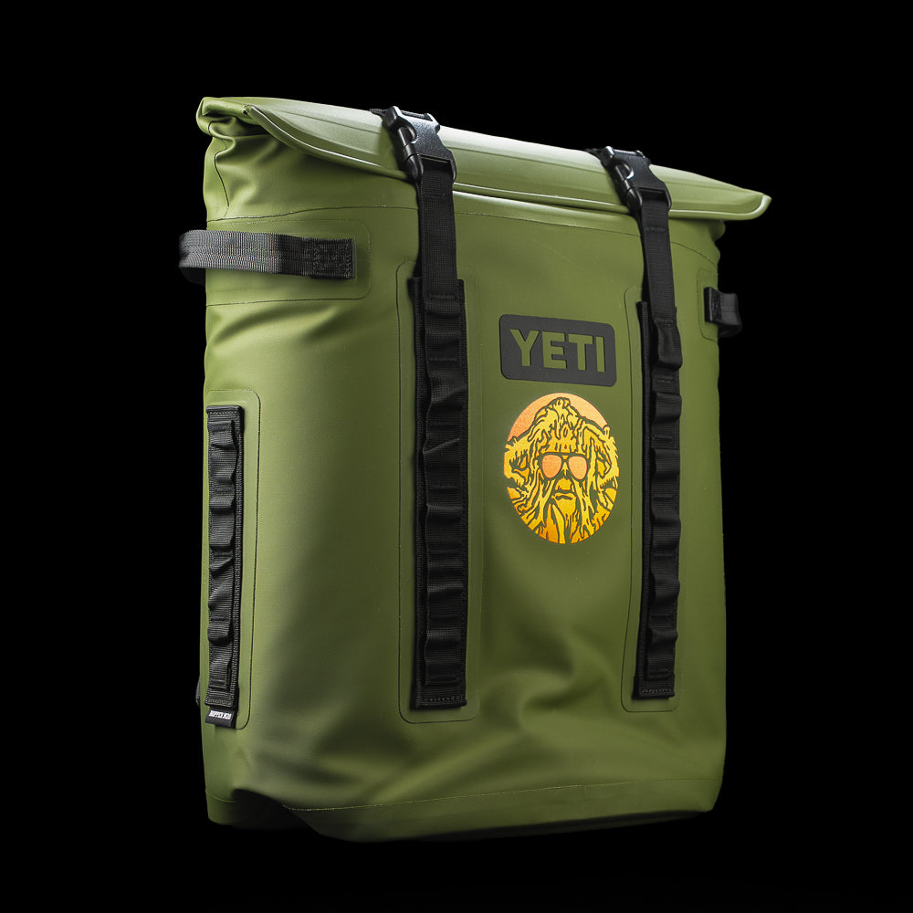 Angled front view of the SWAG Golf x YETI Hopper M20 backpack soft cooler with the Swag Thing graphic, MagShield closure, and YETI branding.