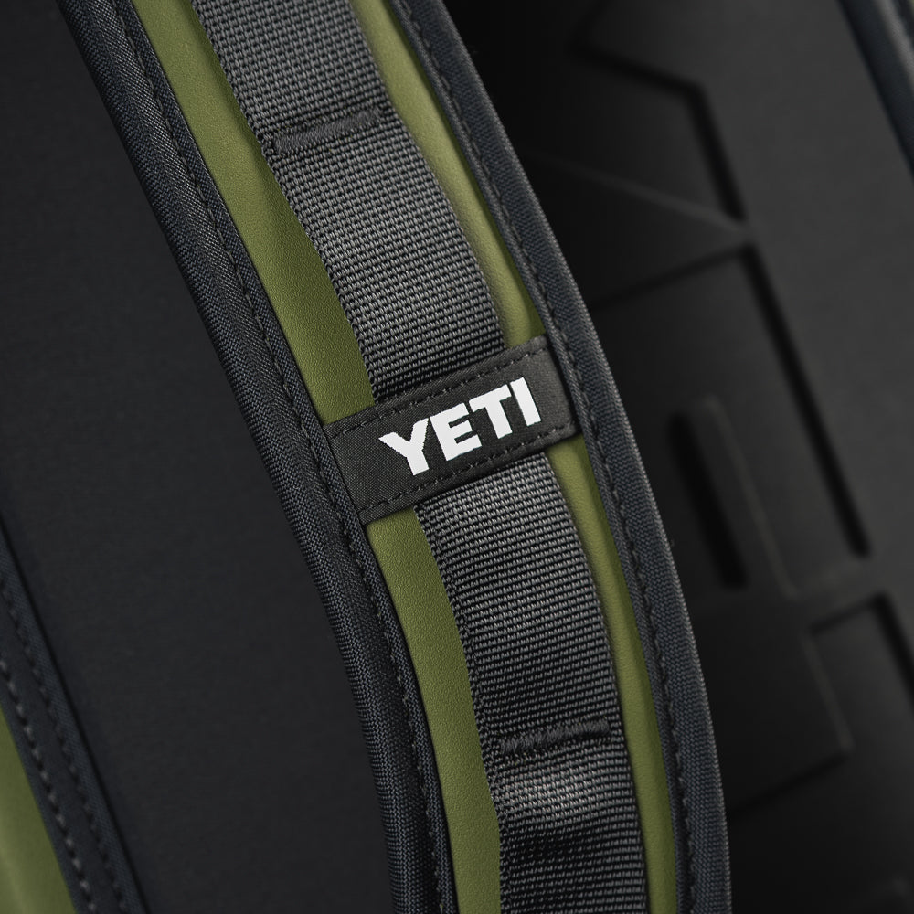 Close-up of the SWAG Golf x YETI Hopper M20 backpack soft cooler shoulder strap showing padded construction and YETI branding.