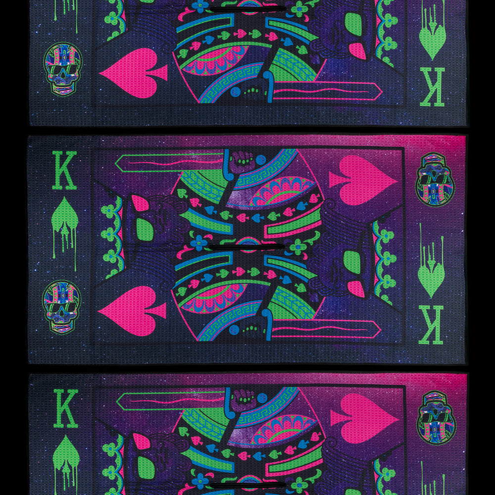 Colorful playing card designs with neon pink, green, and blue on a black background