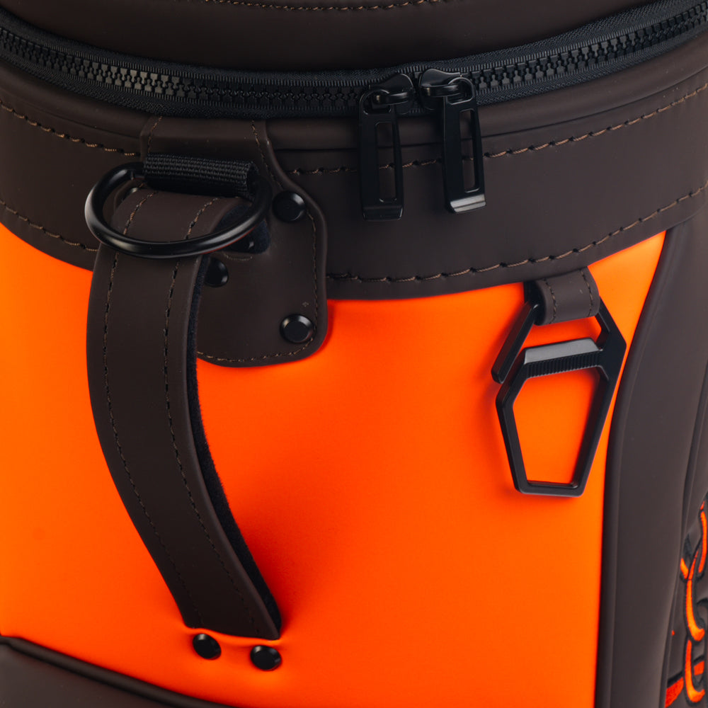 Close-up of the Cleveland Browns Den Caddy Cooler zipper, handle, and orange and brown panels.