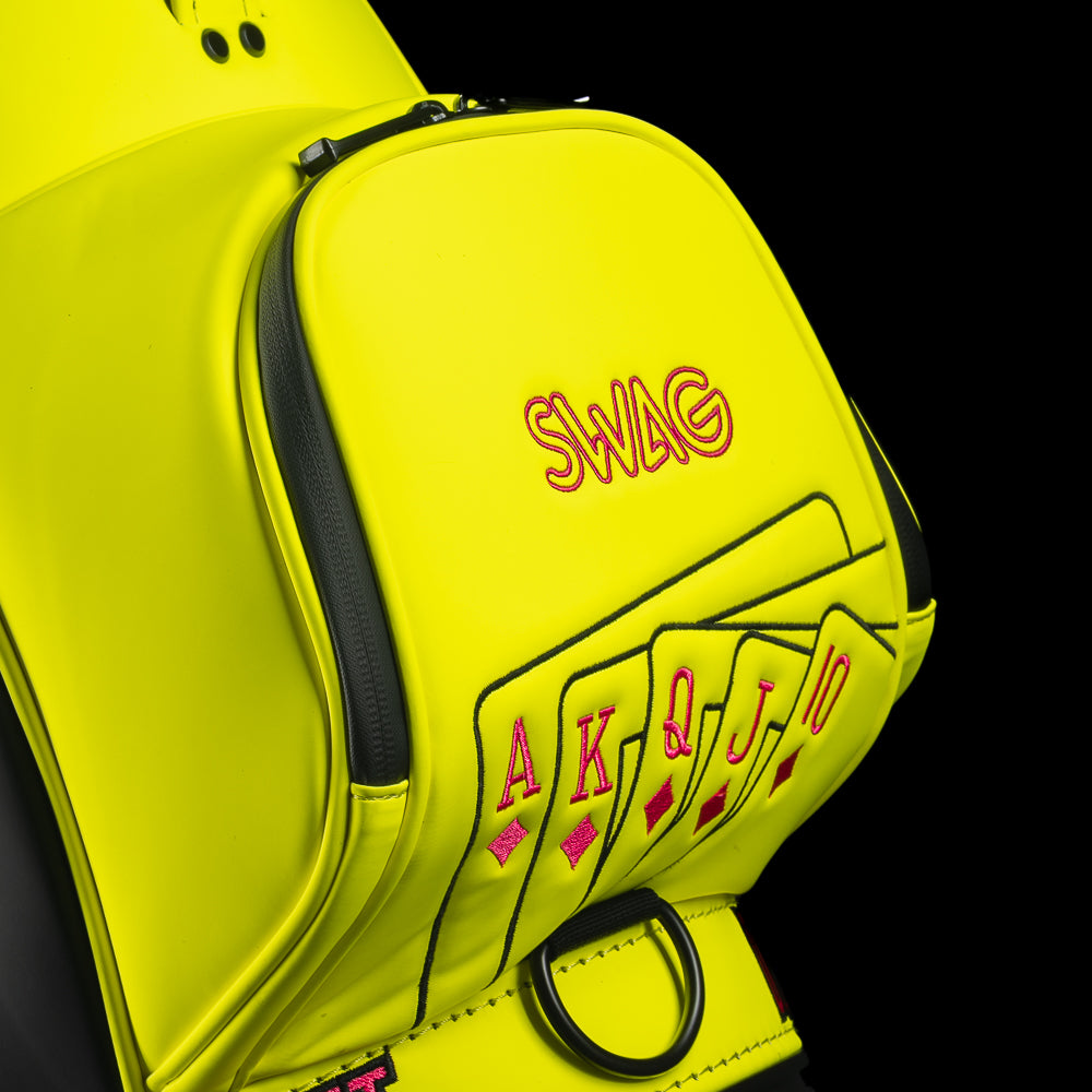 Neon yellow SWAG Golf den caddy zippered cooler with neon pink and black King playing card embroidered design.