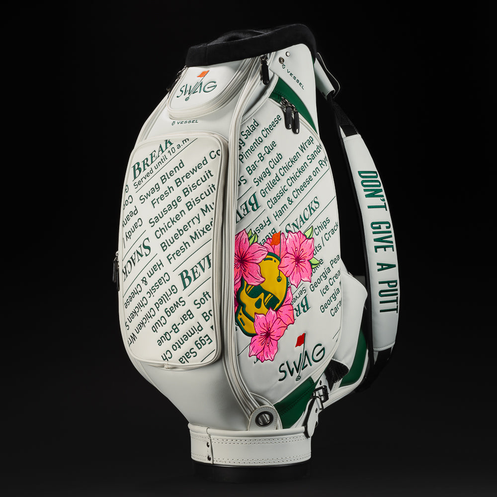 Azalea Yellow Skull with pink hibiscus white tour staff bag with green writing of the Menu.  