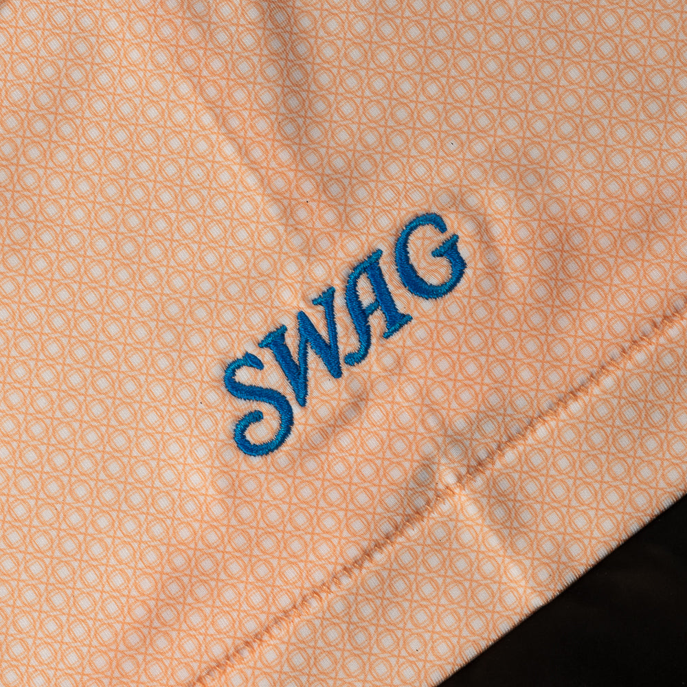 Swag x Peter Millar men's orange short sleeve performance golf polo shirt.