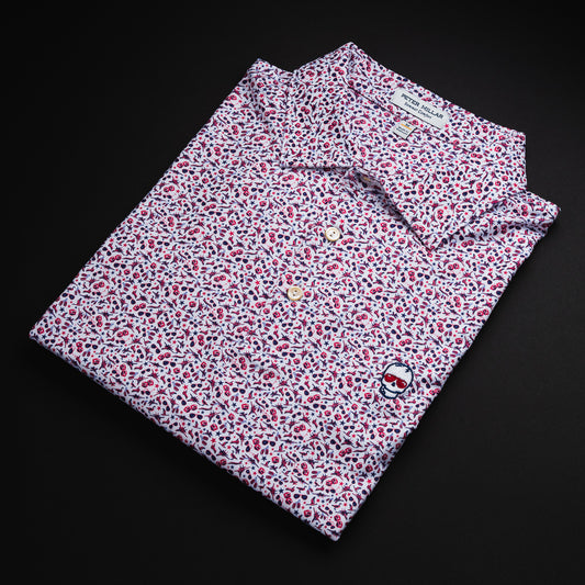 Swag x Peter Millar men's white, pink and red aviation themed custom print short sleeve golf polo shirt with an embroidered skull on the left chest.