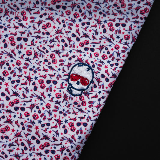 Swag x Peter Millar men's white, pink and red aviation themed custom print short sleeve golf polo shirt with an embroidered skull on the left chest.