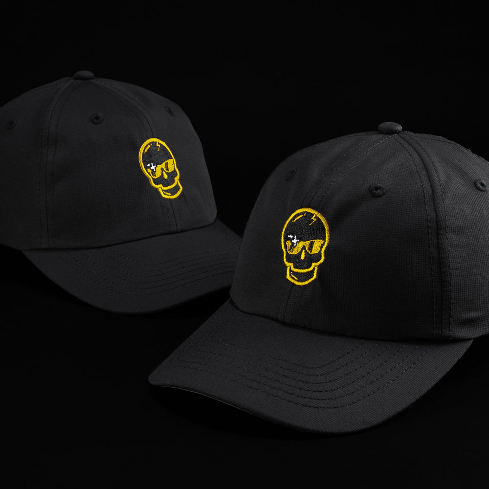 SWAG x Imperial black performance golf hat with yellow sparkle skull logo.