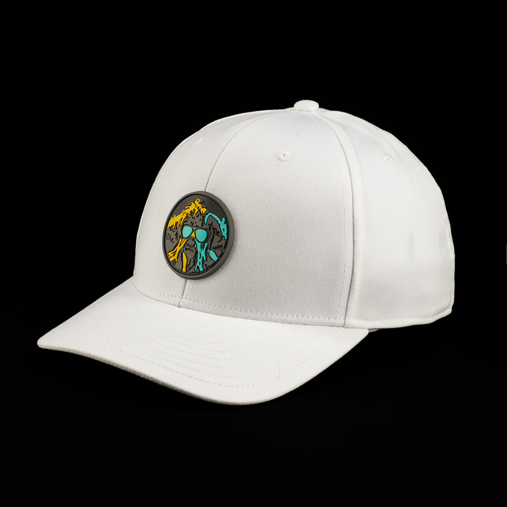 White SWAG Thing hat featuring a round multicolor SWAG Thing patch with teal, orange, and black artwork on the front and center.