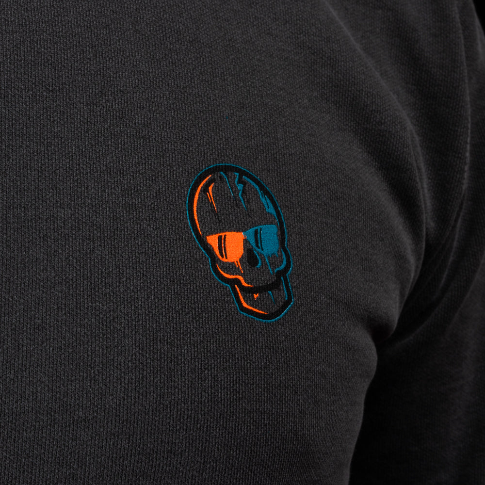 Close-up of the embroidered orange-and-teal SWAG Golf skull logo.