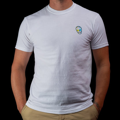 Front view of a white SWAG Golf Greatest Hits T-shirt featuring a small blue-and-yellow skull logo on the left chest.