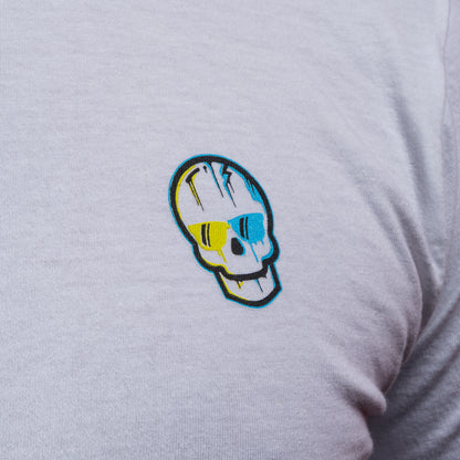 Close-up of the blue-and-yellow SWAG Golf skull logo printed on the white T-shirt.