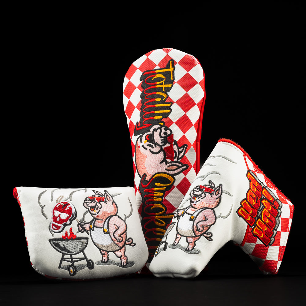 Totally Smoked fairway, blade and mallet golf head covers with red and white checkers and a pig character in red sunglasses grilling.