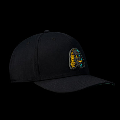 Side view of the Black Defaced Franklin hat featuring a patch of Franklin’s face illustrated in teal, orange, and black.