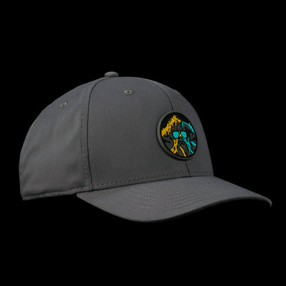 Grey SWAG Thing golf hat with a round, multicolor SWAG Thing patch on the front featuring yellow, teal, and black graphic detailing.