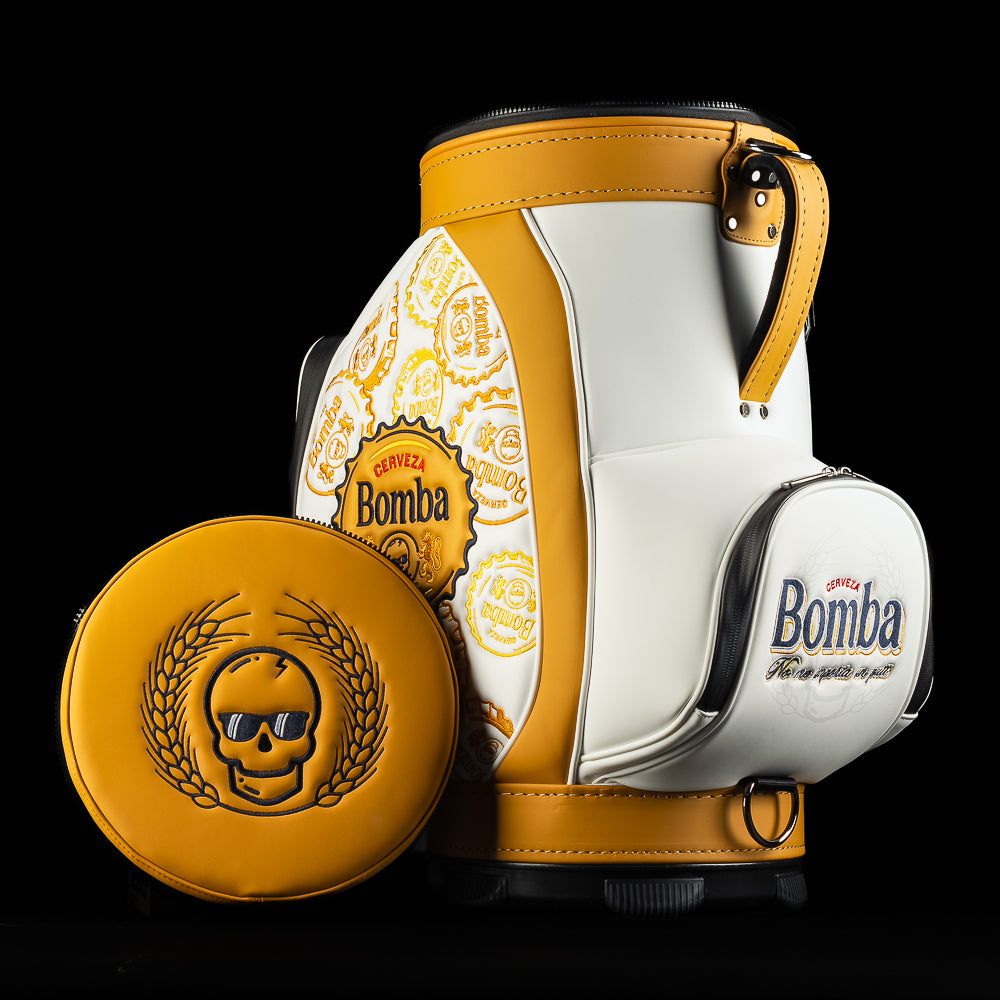 White and gold Bomba Den Caddy golf bag with removable lid featuring SWAG skull logo with sunglasses.