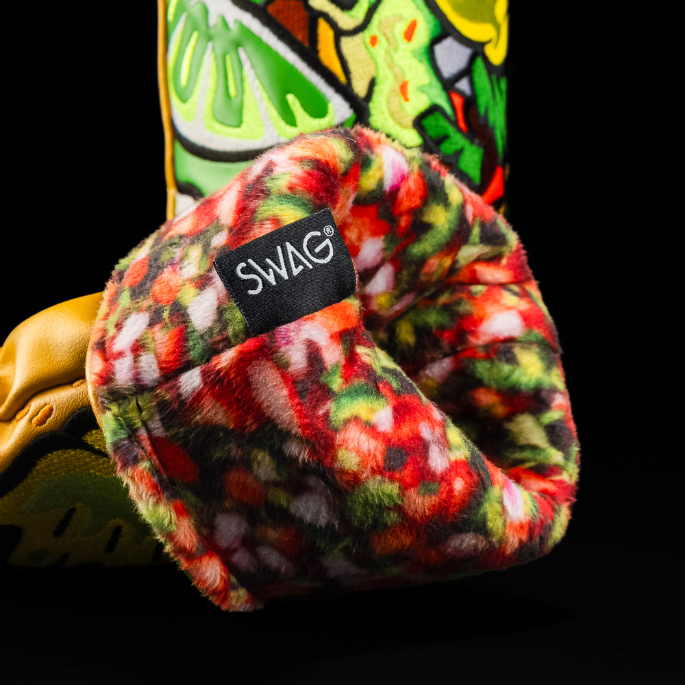 Close-up of multicolor patterned fleece lining inside a SWAG Golf fairway chorizo glizzy fairway cover with black SWAG tag.