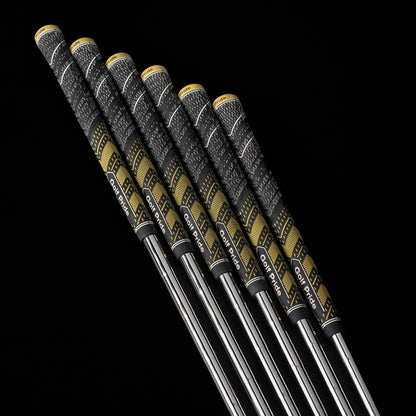 Four golf clubs with black and gold grips on a black background