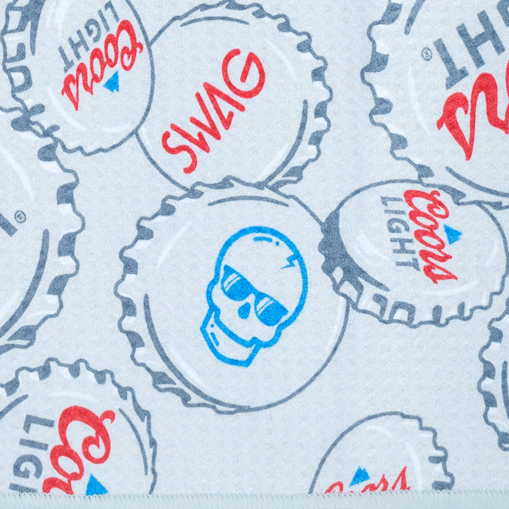 SWAG x Coors Light branded golf towel with stacked bottle caps design on a white background.