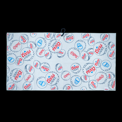 SWAG x Coors Light branded golf towel with stacked bottle caps design on a white background.
