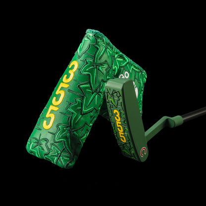 A green ivy Chicago Cubs x SWAG Golf putter and matching headcover shown against a solid black background. The headcover features a textured green ivy pattern with yellow '355' numbers, and the putter head is also green with yellow branding.
