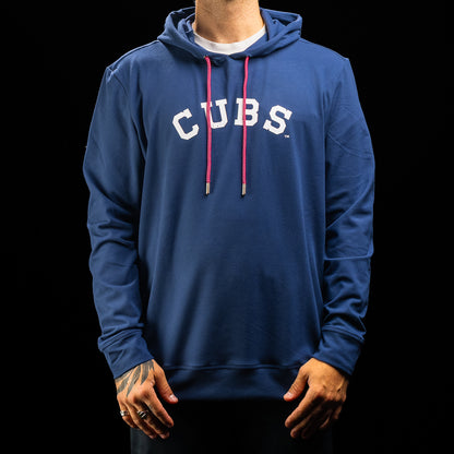 A person wearing a royal blue pullover hoodie with 'CUBS' printed in white arched letters across the chest and bright pink drawstrings, shown against a black background.