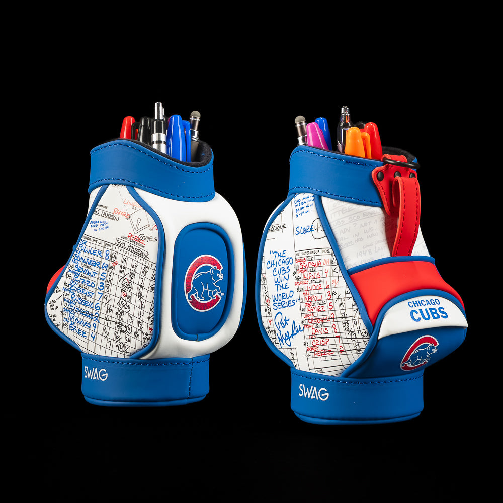 Two Chicago Cubs-themed pen holders shown from the front and back against a solid black background. The holders are blue and white with red accents, featuring the Cubs logo, team colors, and autographed writing on the back panels.