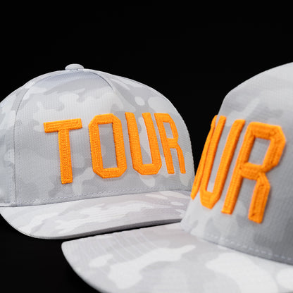 G/FORE Tour Flexfit men's performance golf hat in white and gray camouflage and orange Tour with orange and black skull. 