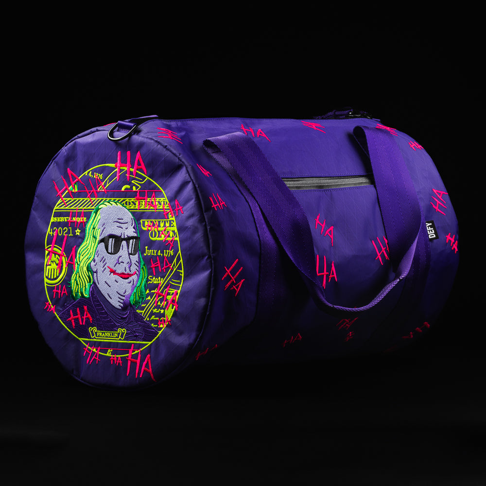 Swag x Defy Defaced Franklin ultimate overnighter purple duffel bag.