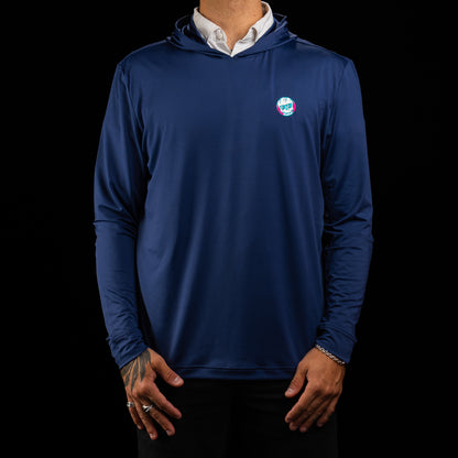 A man wearing a navy blue long-sleeve performance golf hoodies over a white collared shirt, shown from the neck down against a solid black background.