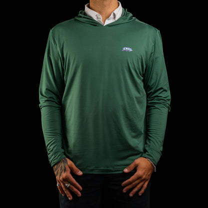 A man wearing a green long-sleeve hooded performance golf hoodie over a white collared shirt, shown from the neck down against a solid black background.