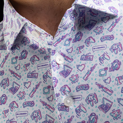 Close-up of a men's white golf polo shirt with a colorful gaming-themed print featuring controllers, retro game consoles, and text reading 'CAN U ANSWER???'.