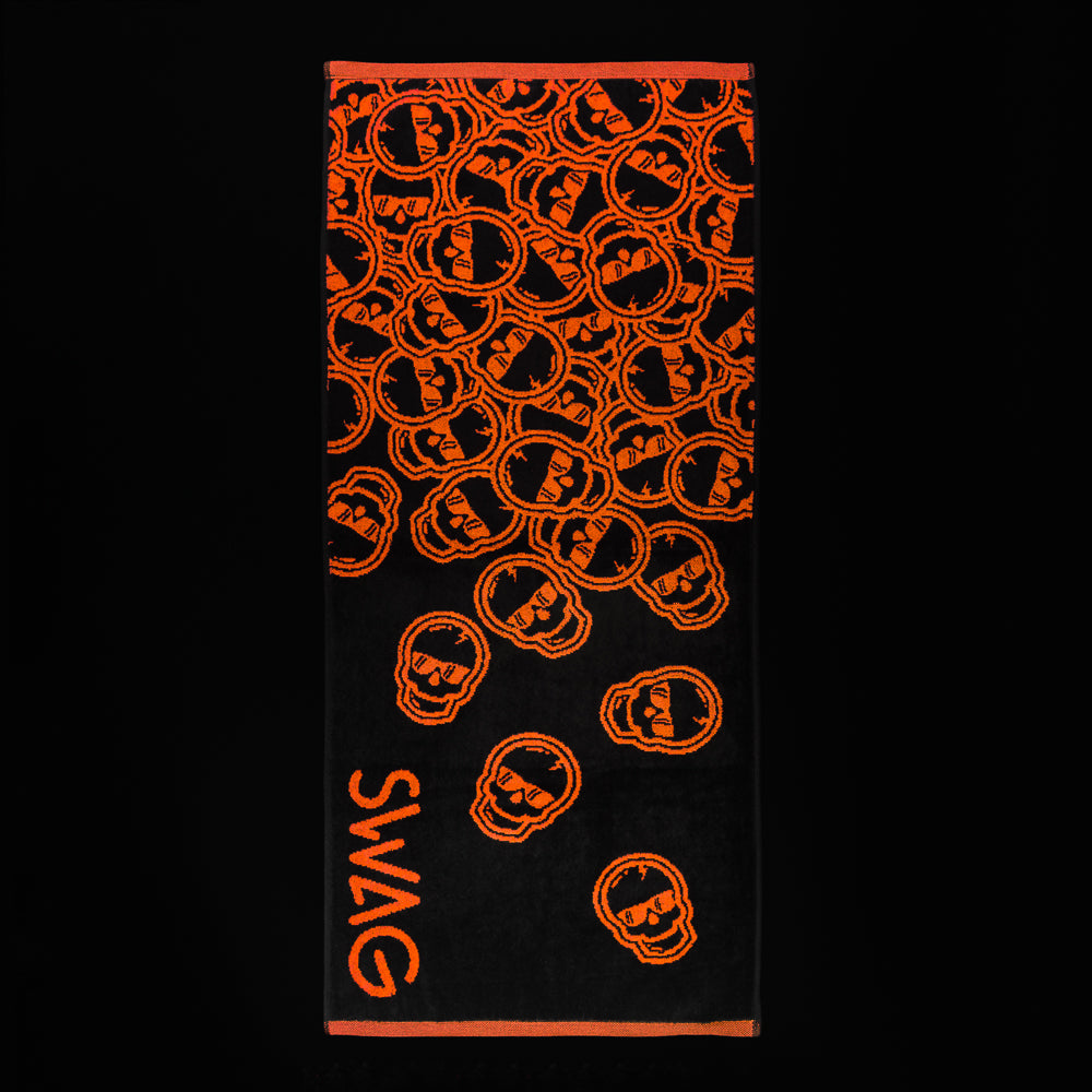 Swag falling skulls orange and black golf towel.