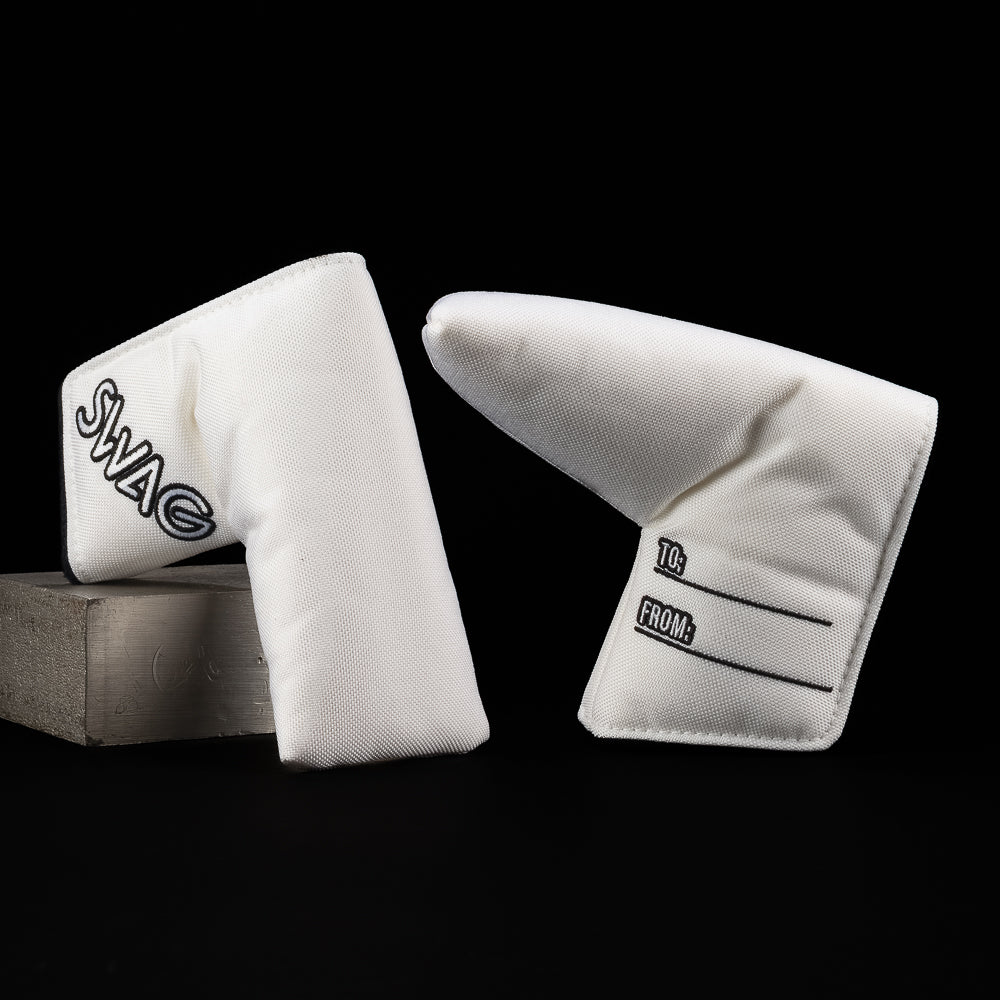 Two white golf club covers with brand logos on a black background