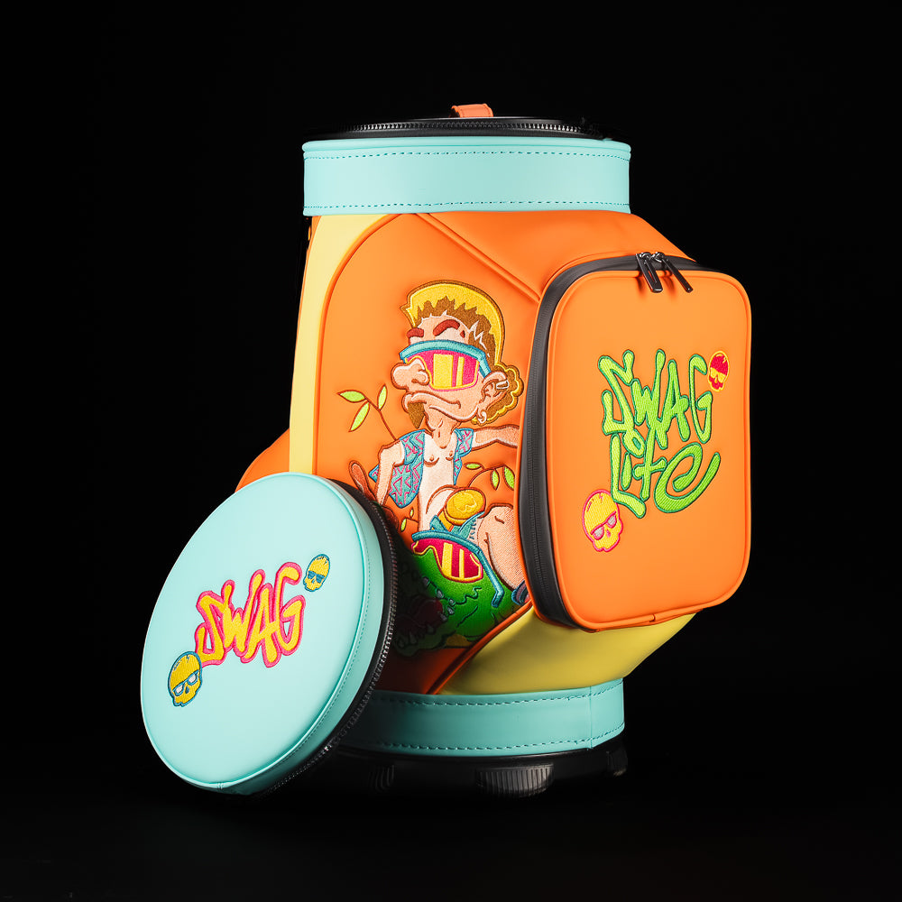 SWAG Golf Florida Man Den Caddy bag in orange and aqua with front zip pocket featuring green SWAG embroidery and neon skull icons.