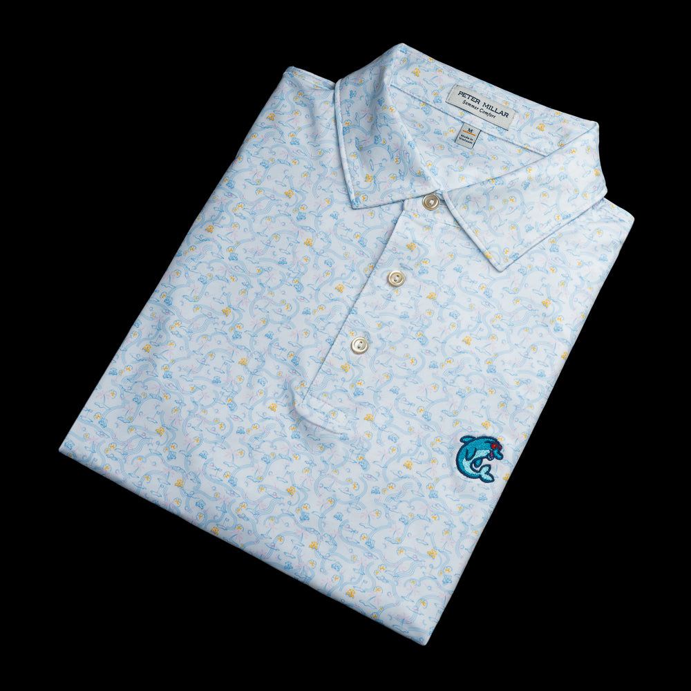 Light blue Peter Millar polo with a tropical golf course pattern and a blue flipper on the left chest.