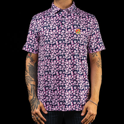SWAG Golf x G/FORE navy and pink floral tech men's golf polo shirt with Miami Flipper logo over the left chest. 