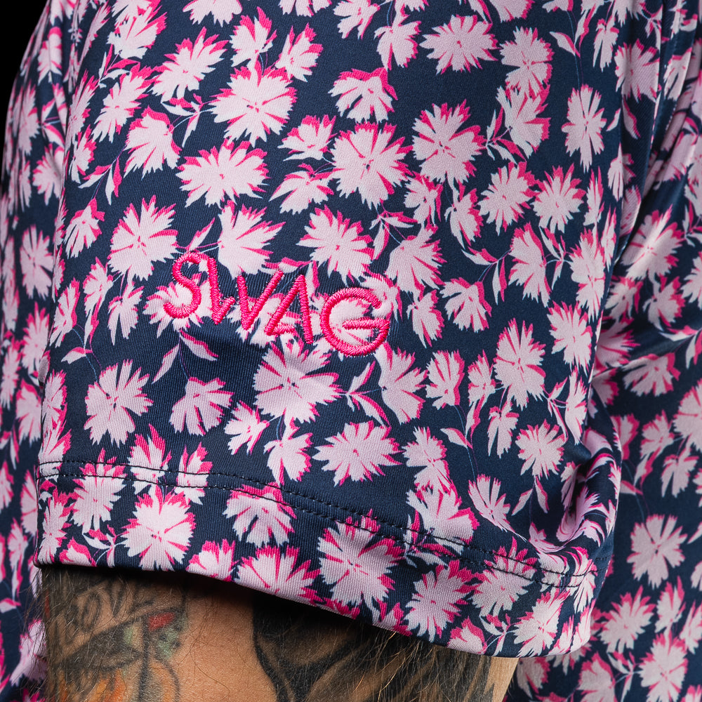 SWAG Golf x G/FORE navy and pink floral tech men's golf polo shirt with Miami Flipper logo over the left chest. 