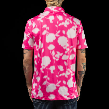 SWAG Golf x G/FORE men's performance golf polo shirt with pink and white floral pattern and a peach skull logo over the left chest.