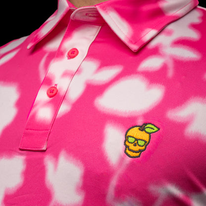 SWAG Golf x G/FORE men's performance golf polo shirt with pink and white floral pattern and a peach skull logo over the left chest.