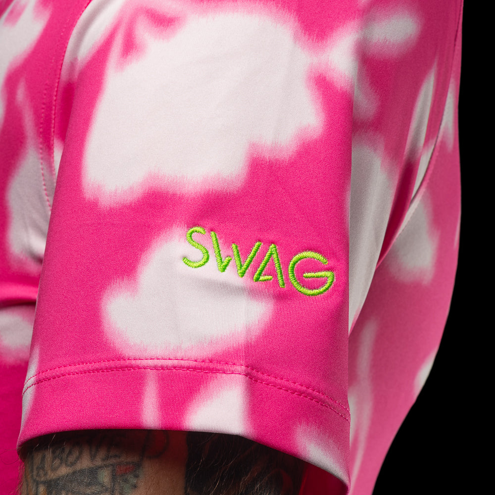SWAG Golf x G/FORE men's performance golf polo shirt with pink and white floral pattern and a peach skull logo over the left chest.