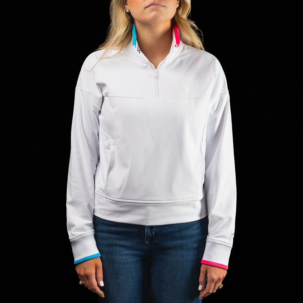 SWAG Golf x G/FORE women's long sleeve white quarter zip with blue and pink accents.