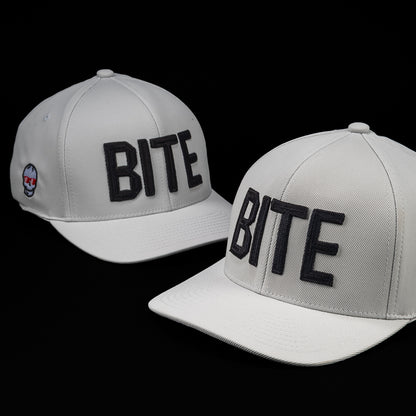 SWAG Golf x G/FORE white flexfit 110 snapback golf hat with BITE letters on the front.